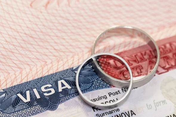 A US visa alongside wedding rings